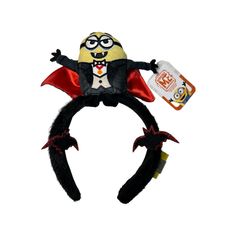 a black and yellow toy with a red cape on it's head, holding a bottle