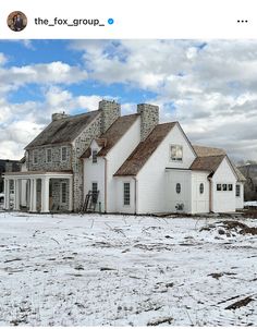 a large white house sitting on top of a snow covered field