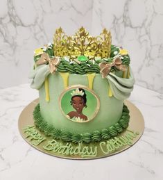 a green cake decorated with a princess's tiara