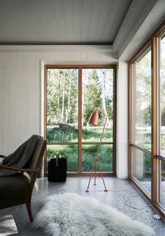 a living room filled with furniture and large windows