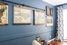 a living room with blue walls and pictures on the wall