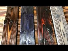 four different colored wood planks sitting on top of each other