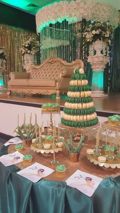 a table topped with cupcakes covered in green frosting and decorated like a christmas tree