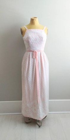 Vintage 1960s lace doily gown. White crocheted lace with a pink fabric lining. Metal zipper up the back. Pretty pink velvet shoulder straps and waist trim. The lining fabric is a medium weight taffeta type fabric. Please note: The bust is on the small size and didn't fit the mannequin. Please look at measurements.Label: Algo Original Condition: Excellent Vintage Bust: 32"Waist: 24"Hips: 46"Length: 52"Mannequin measurements for reference... Bust: 35" Waist: 27" Hips: 38" Long Maxi Gowns, Gown White, Lace Doily, Crochet Maxi, Gown Photos, Maxi Gown, Crocheted Lace, Short Playsuit, White Lace Dress