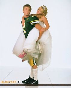 a man and woman dressed up in football uniforms