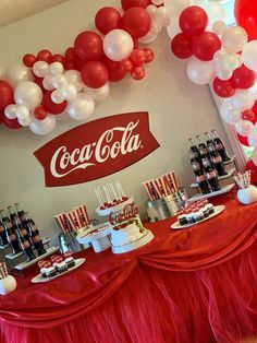 a coca - cola themed party with balloons and desserts