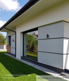 an exterior view of a house with grass and windows