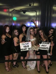 a group of women standing next to each other holding signs