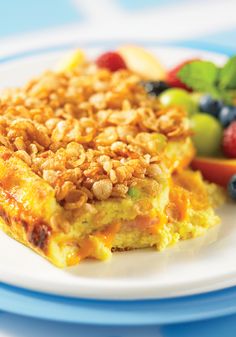 an omelet on a plate with fruit in the background