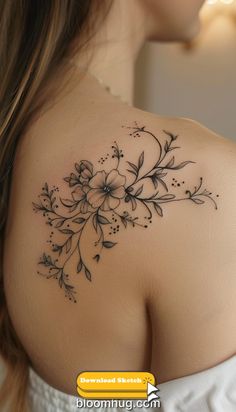 the back of a woman's shoulder with flowers on it