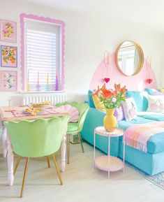 a living room filled with lots of furniture and colorful decor on top of wooden floors