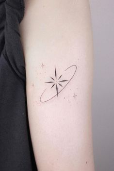 a woman's arm with a small star tattoo on it