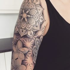 a woman's arm with a flower tattoo on the left side of her arm