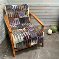 a wooden chair sitting on top of a tiled floor