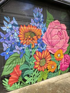 a garage door painted with flowers and leaves