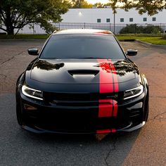 the front end of a black and red chevrolet camaro parked in a parking lot