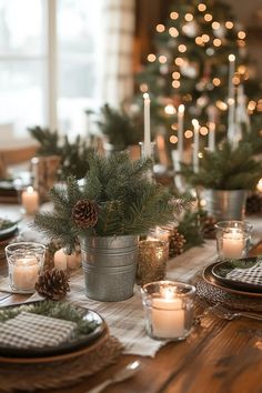 the table is set with pine cones and candles