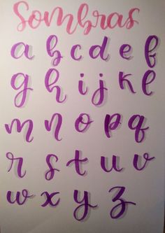 some type of writing that is made out of purple and pink paper with the letters on it