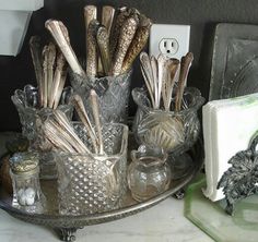 an assortment of glass items on a metal tray