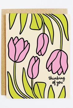 a greeting card with pink flowers and green leaves on the front, says thinking of you