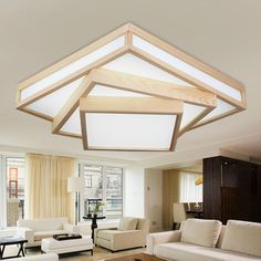 a living room filled with white furniture and lots of windows