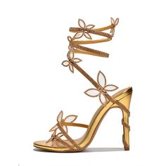 Step into the spotlight with our Gold Open Toe Party Shoes. These stunning sandals feature a rhinestone butterfly design and wrapped heels, perfect for adding glamour to any special occasion. Color: Gold Heel Type: Stiletto heel Heel height: 4.5" / 115 mm approx Product measurements were taken using size 8. Please note that measurements may vary by size. Toe: Open toe Wrapped style Rhinestone and butterfly embellishment Handcrafted US sizing. Fits true to size. Gold Heels Wedding, Hoco Heels, Wrap Around Heels, Butterfly Heels, Pencil Heels, Golden Shoes, Butterfly Shoes, Cowboy Shoes, Formal Heels