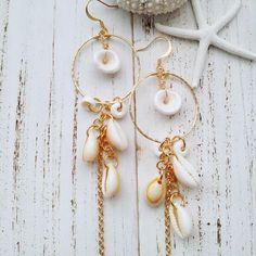 "》》》 DESCRIPTION 《《《 -Cowry shells and white puka shells on hammered hoops -Gold plated-non tarnish -Hoop size: 1 1/4\" widest point -Medium size Hoops -Hypoallergenic and Nickle Free -Processing time: 7-14 Business days ( not including weekends) ♥ G I F T W R A P P I N G ♥: Included at no additional cost! Just check the box \"This is a gift\" at checkout! And make sure to add a gift message so they know its from you!" White Shell Dangle Jewelry, White Small Hoop Earrings For Beach, White Hoop Earrings For Vacation, White Small Hoop Jewelry For The Beach, White Beaded Hoop Earrings For Beach, Hoop Earrings Medium, Gold Schmuck, Cowry Shell, Hoops Gold