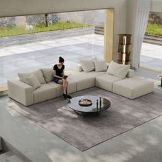 a woman sitting on top of a couch in a living room