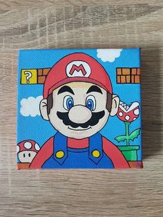 an image of a nintendo mario painting on wood