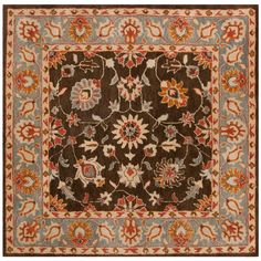 a brown and blue rug with flowers on it