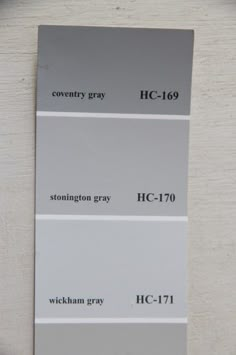 some gray and white paint swatches on a wall