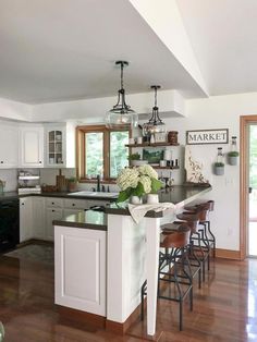 a kitchen with an island and bar stools