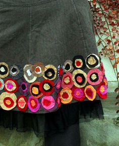 there is a skirt made out of different colored pieces of fabric and buttons on it