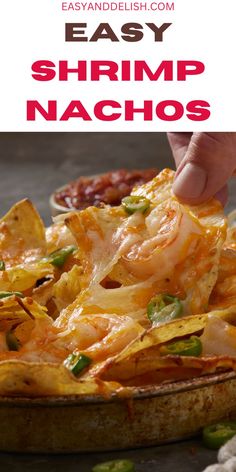 a person dipping some food into a dish with text overlay that reads easy shrimp nachos