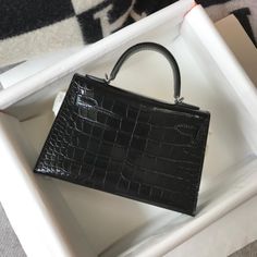 Hermes Mini Kelly 19 Black Silver Toned Hardware Bag For Women, Women’s Handbags, Shoulder Bags 7.5in/19cm Rep 1:1 19 x 11.5 x 5.5 cm / 7.5 x 4.5 x 2.2 inches (Length x Height x Width) Medium compartment Silver-toned hardware Interior with 1 side zippered pocket A protective footed bottom Adjustable shoulder strap Includes box, ... Mini Kelly, Louis Vuitton Shirt, Chanel Shirt, Womens Handbags, Call Backs, Hermes Bags, Evening Clutch Bag, Accessories Store, Bag For Women