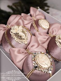 some pink and gold ornaments in a box