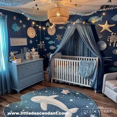 a baby's room is decorated in blue and white with stars, fish, and other decorations