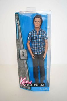 the action figure is in its package and has a blue plaid shirt on it's head