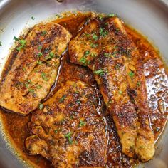 some meat is cooking in a pan on the stove