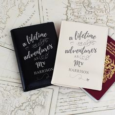 two passport covers sitting next to each other on top of an old world map,