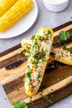 grilled corn on the cob with parsley sprinkled cheese and herbs