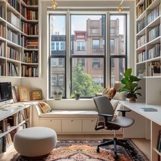 a home office with lots of bookshelves and a window seat