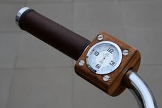 a close up of a clock on the handlebars of a bike