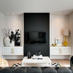 a black and white living room with art on the wall