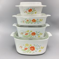 four white dishes with flowers painted on them