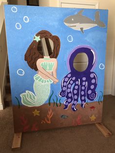 a child's painting of a mermaid and an octopus