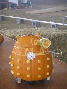 two pumpkins that have been carved to look like doctor who is sitting on the ground