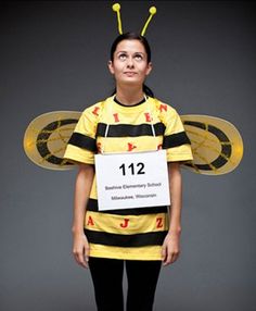 a woman dressed as a bee holding a sign with the number twelve on it's chest