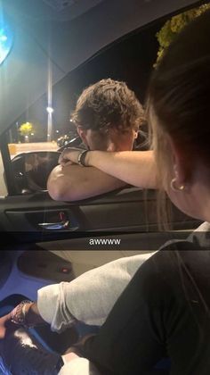 two women sitting in the back seat of a car