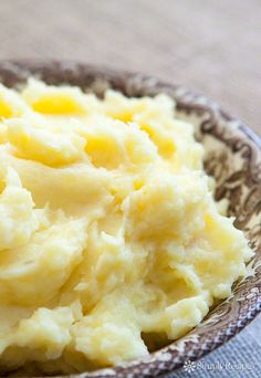 a bowl filled with mashed potatoes on top of a table